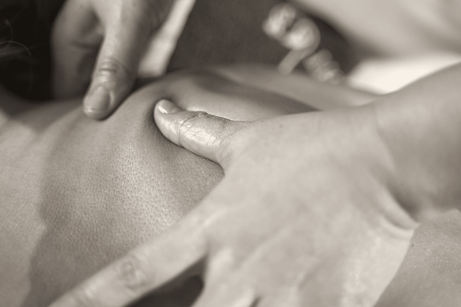 Close-up of hands working on a shoulder during a massage