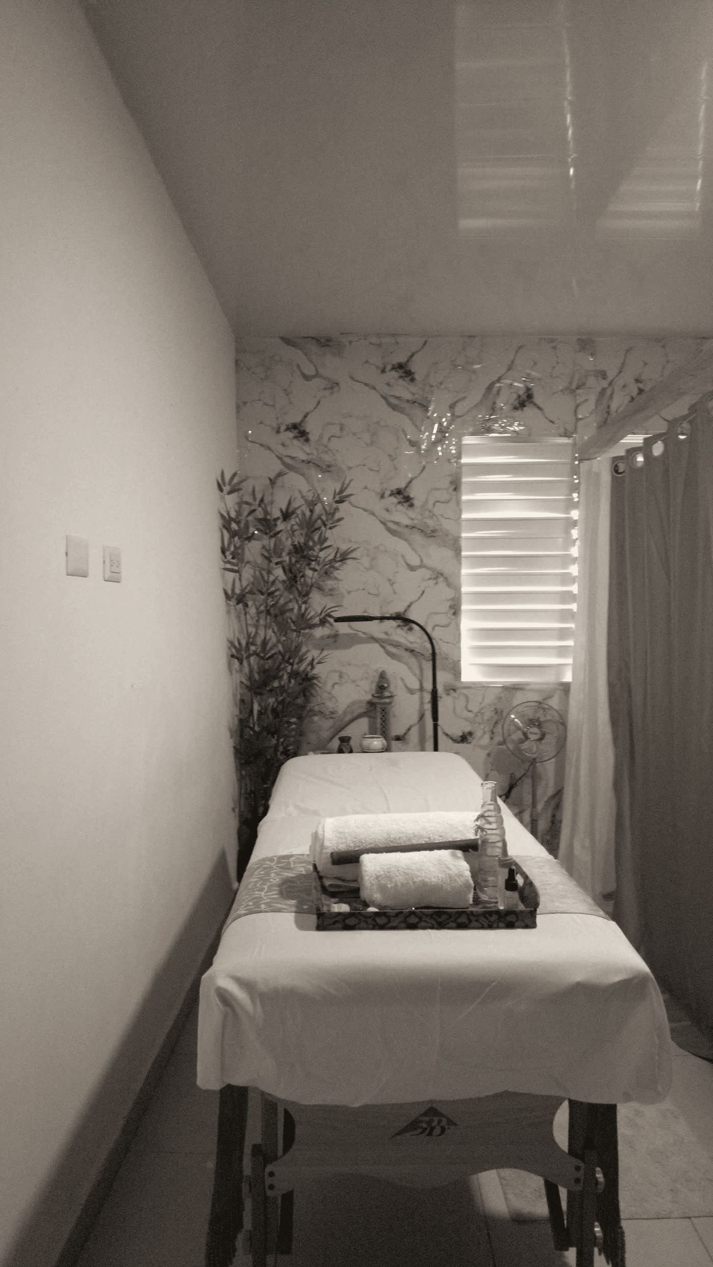 The treatment room at Lotus, marble wall, bamboo, and natural light